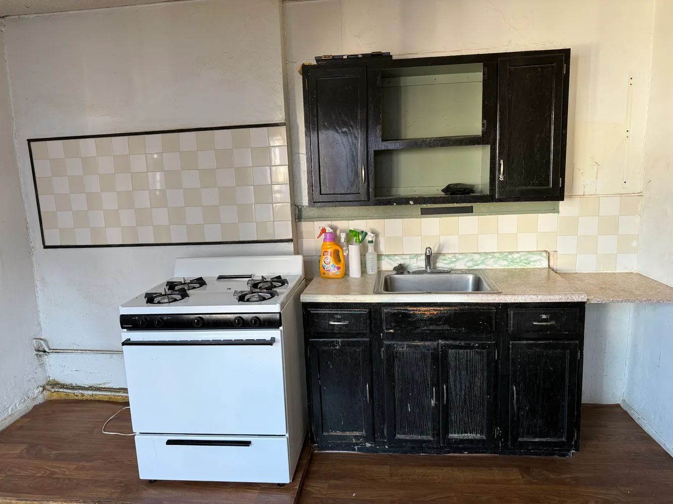 a kitchen with a sink and a stove top oven