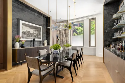 a dining room with furniture a chandelier and wooden floor