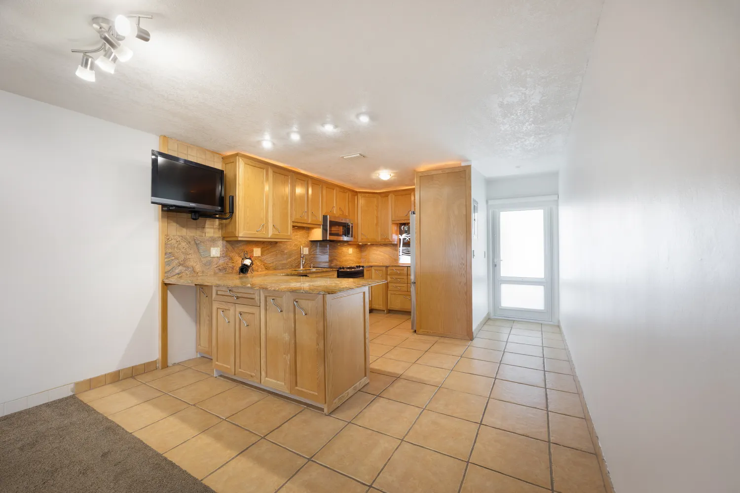 a kitchen with stainless steel appliances granite countertop a sink and a stove