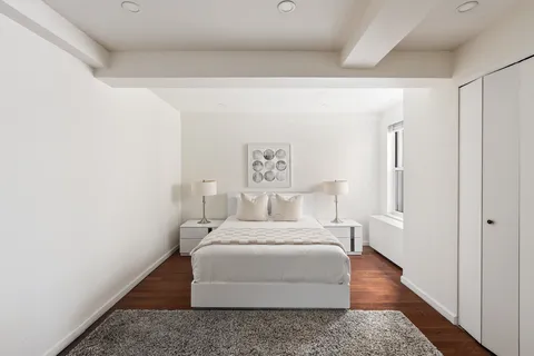 a room with a bed and wooden floor