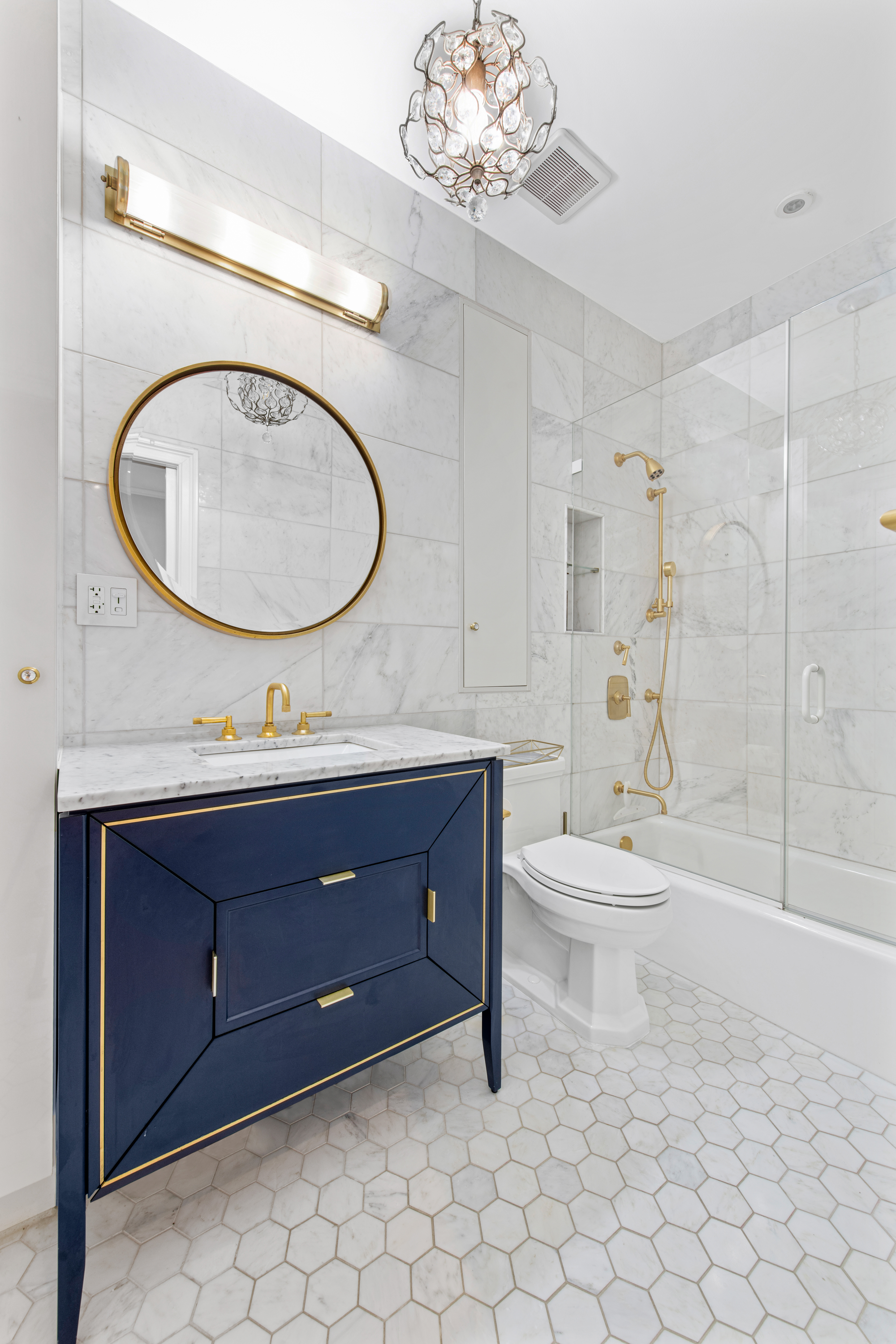 135 Ridge Street, Unit 5A Manhattan, NY 10002 - Photo 8 of 11 a bathroom with a toilet a double vanity sink and a mirror