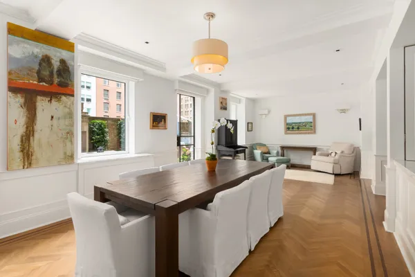 a kitchen with furniture and a chandelier