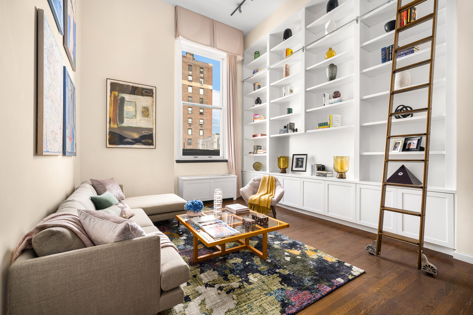 a living room with furniture and next to a window