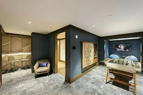 a living room with furniture a ceiling fan and a window