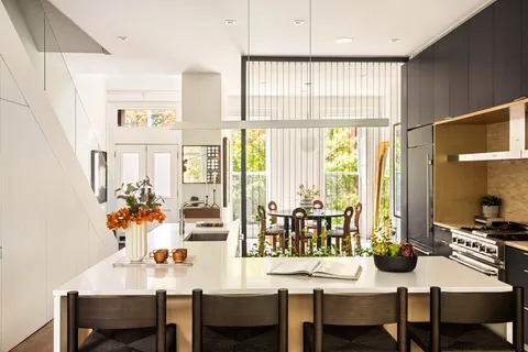 a view of a dining room with furniture and a window