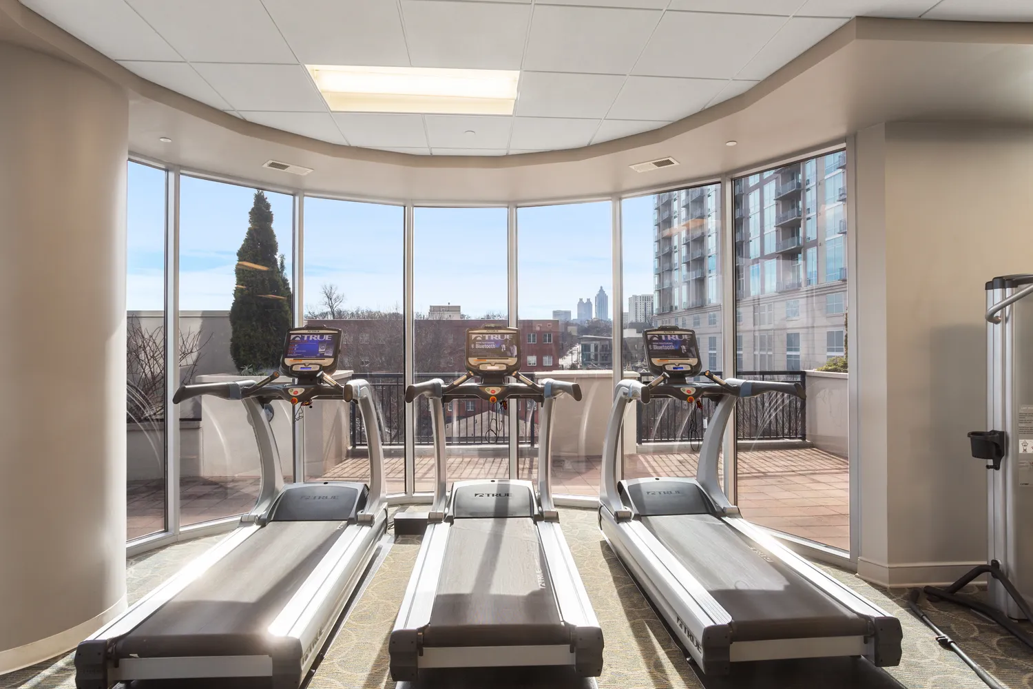 a room with gym equipment and a large window