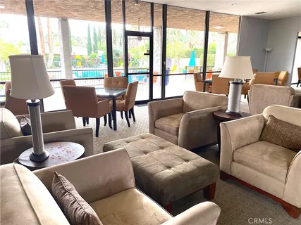 a living room with furniture wooden floor and a large window