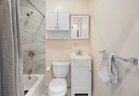 a bathroom with a toilet sink and shower