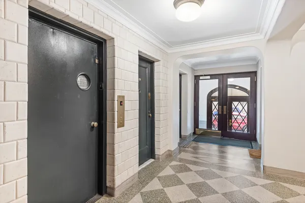 a view of a hallway with wooden door