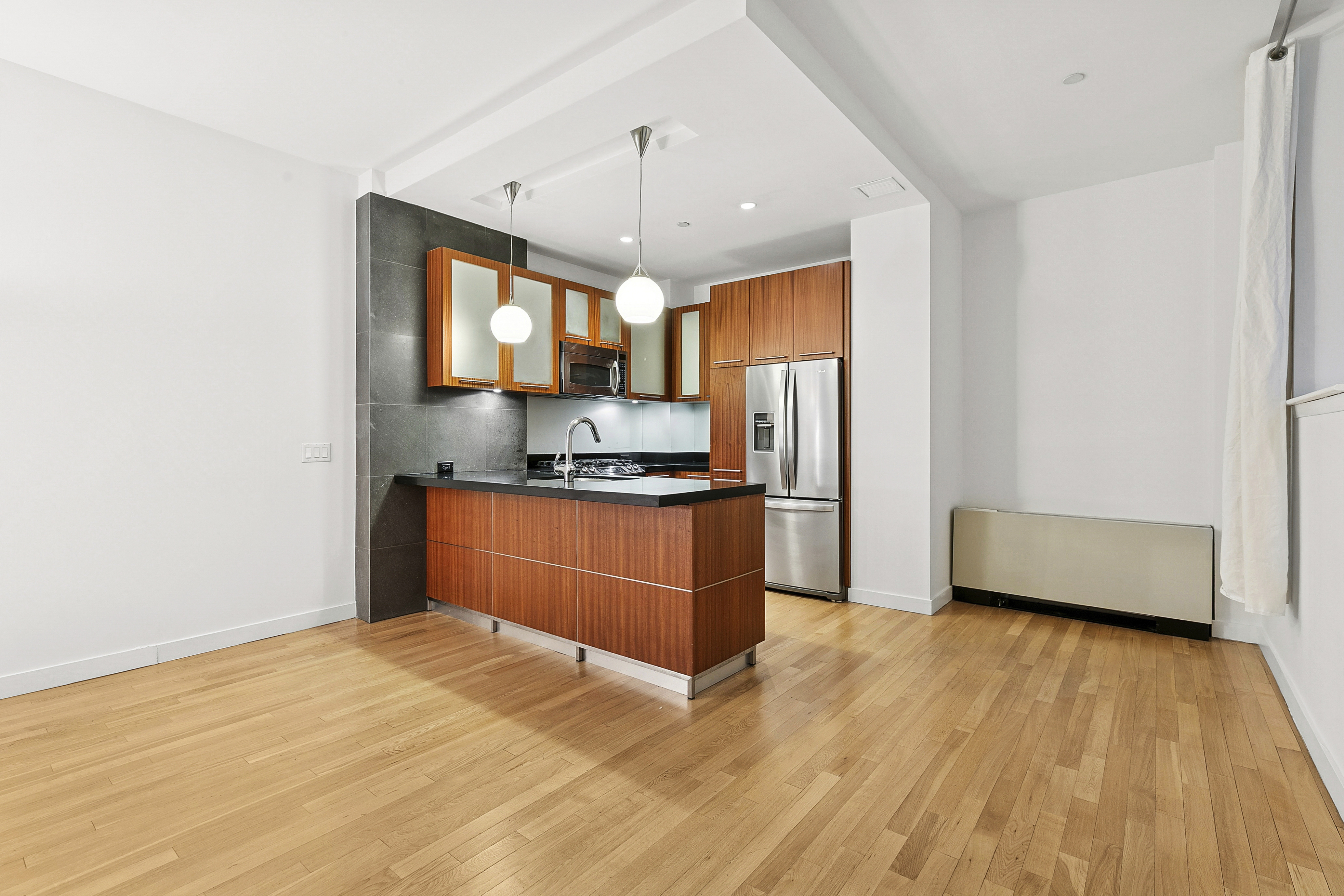 59 John Street, Unit 4H Manhattan, NY 10038 - Photo 6 of 19 a kitchen with stainless steel appliances granite countertop a stove and a refrigerator