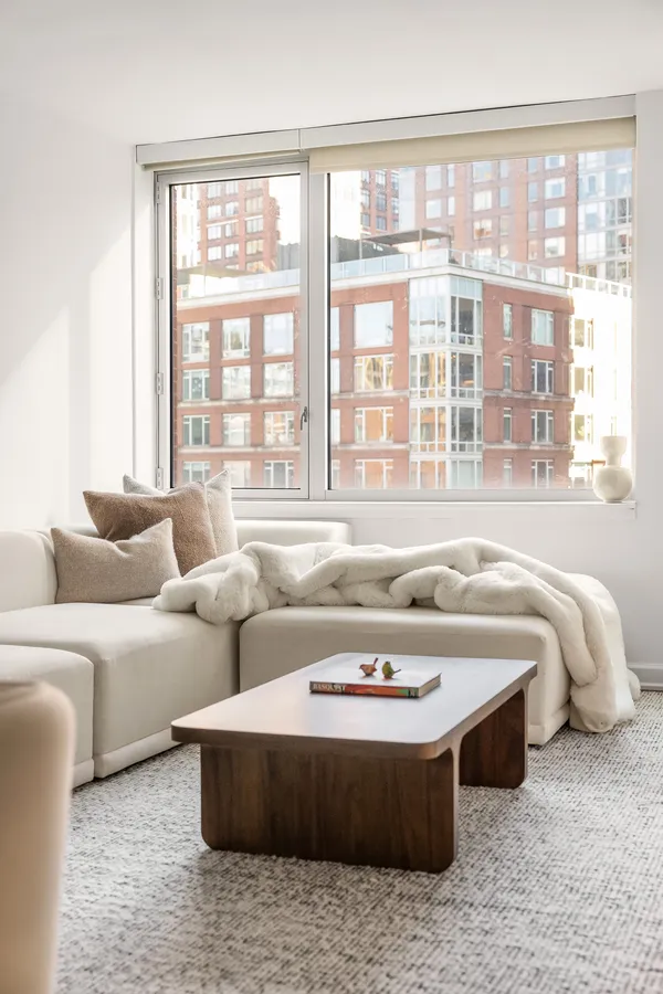 a spacious bedroom with furniture and a large window