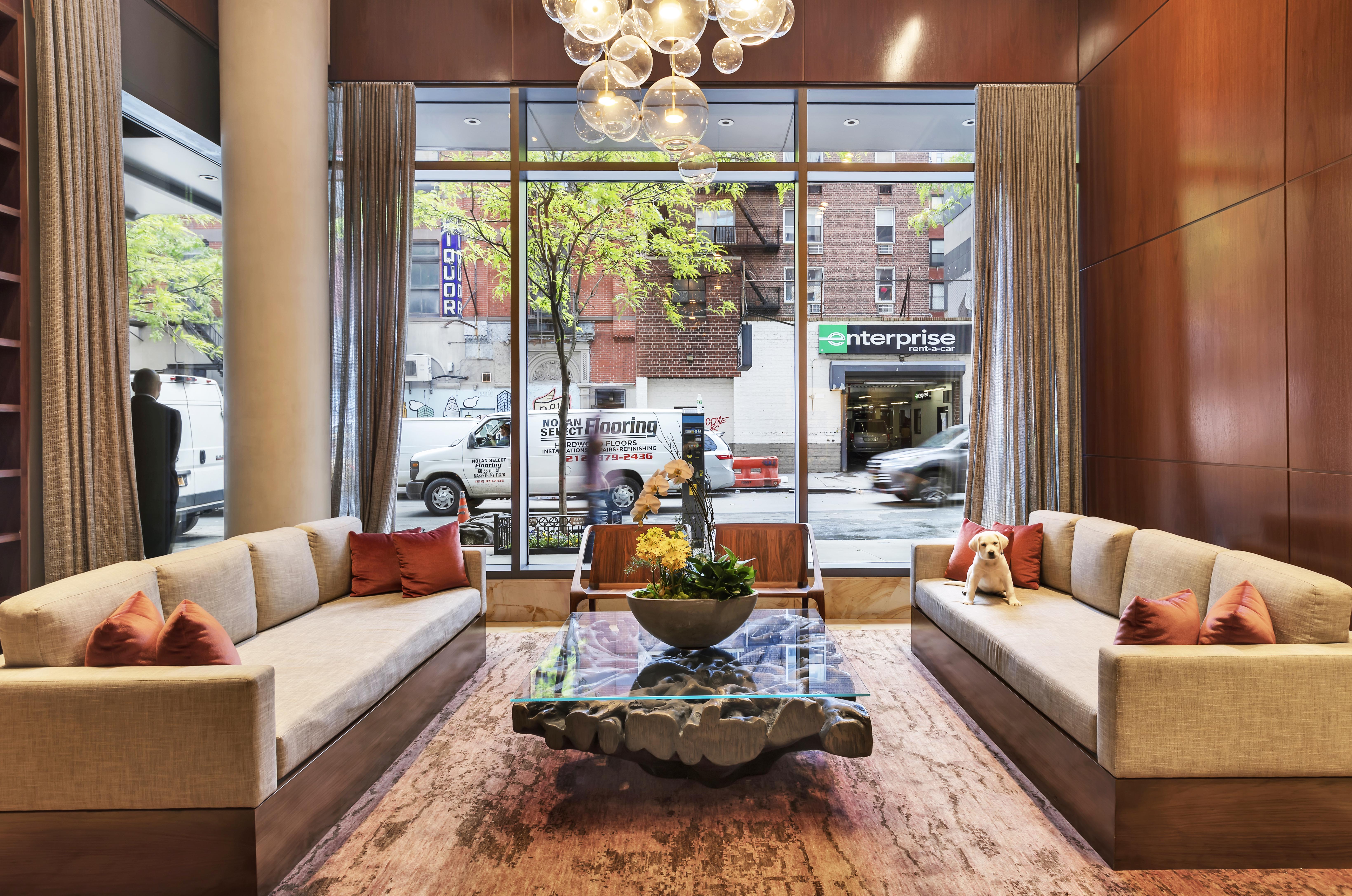 101 West 24th Street, Unit 16D Manhattan, NY 10011 - Photo 14 of 23 a living room with furniture and a large window
