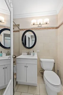 a bathroom with a toilet a sink and a mirror