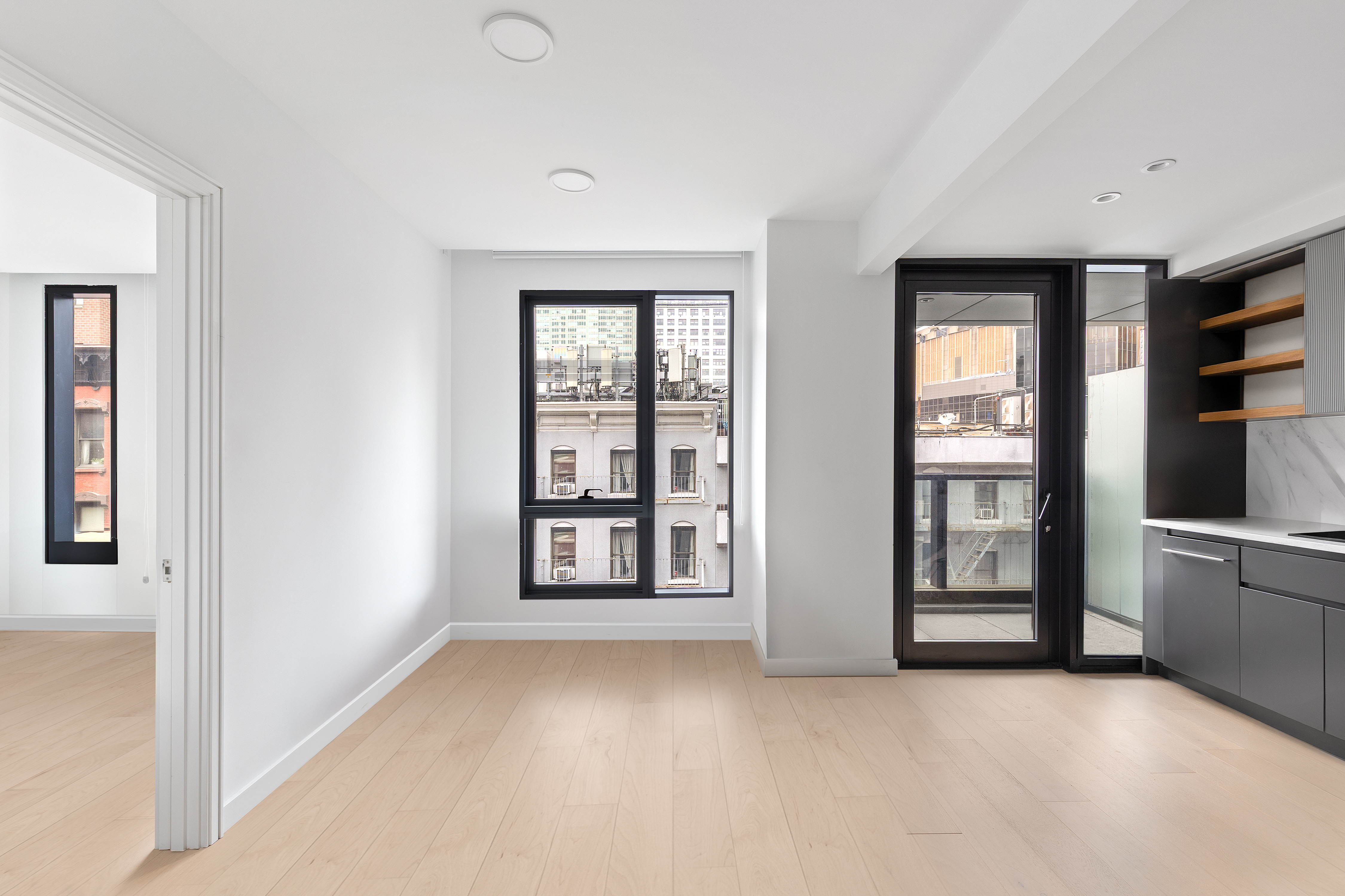 300 West 30th Street, Unit 4A Manhattan, NY 10001 - Photo 7 of 15 an empty room with windows and cabinet