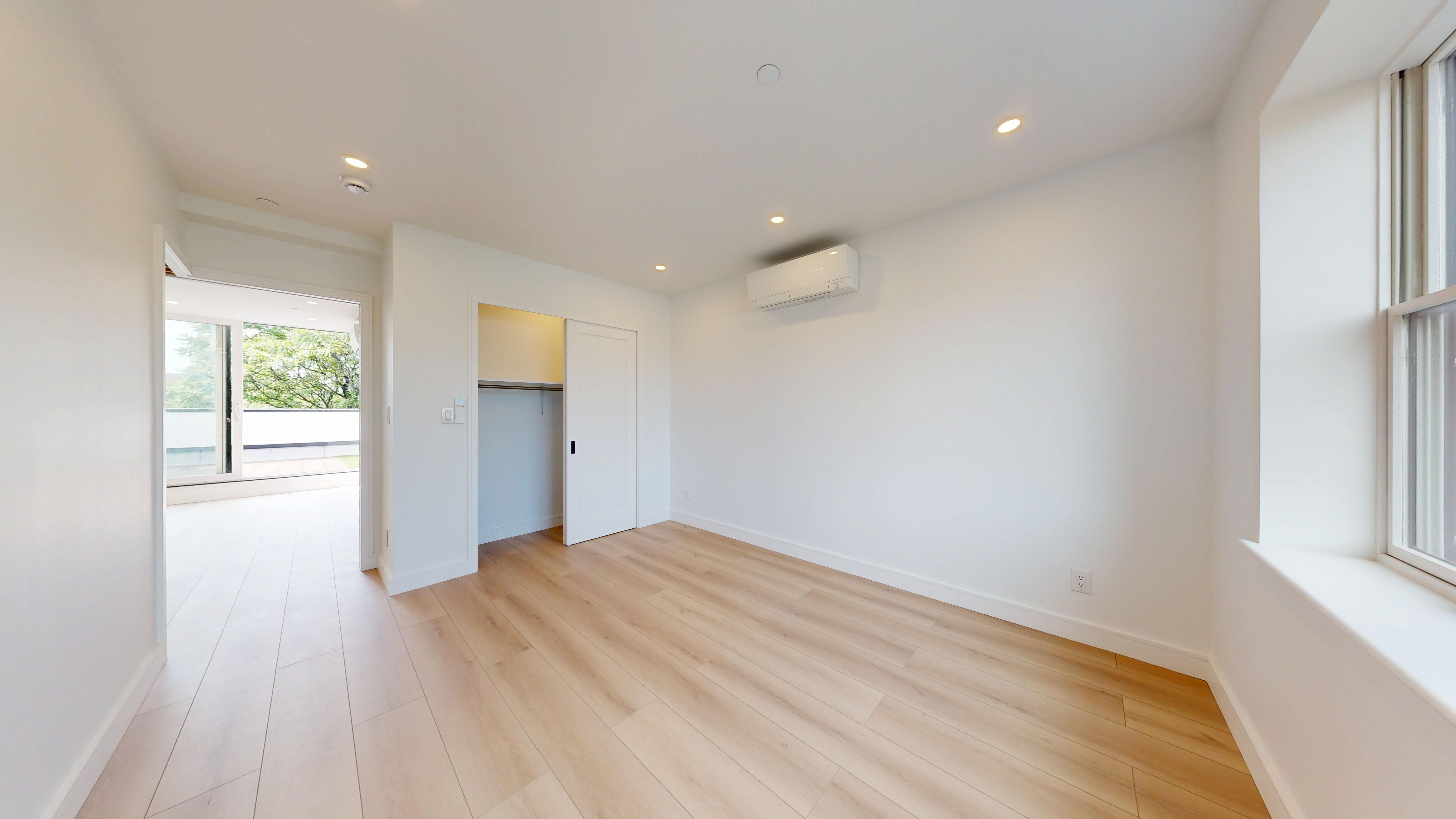5614 3rd Avenue, Unit 3 Brooklyn, NY 11220 - Photo 11 of 11 a view of empty room with wooden floor and fan