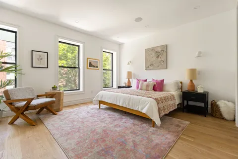 a spacious bedroom with a bed and a couch