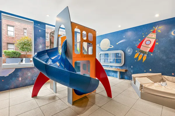 a living room with furniture and floor to ceiling windows