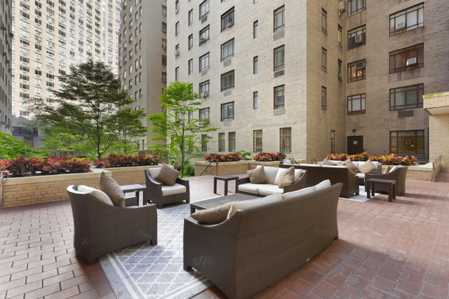 25 Central Park West, Unit 2W Manhattan, NY 10023 - Photo 7 of 12 a view of a patio with couches and a potted plant on a sidewalk