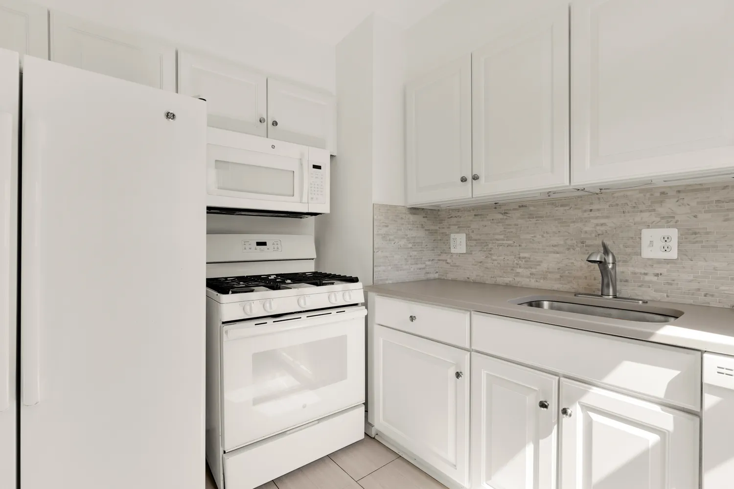 a kitchen with cabinets appliances and a sink