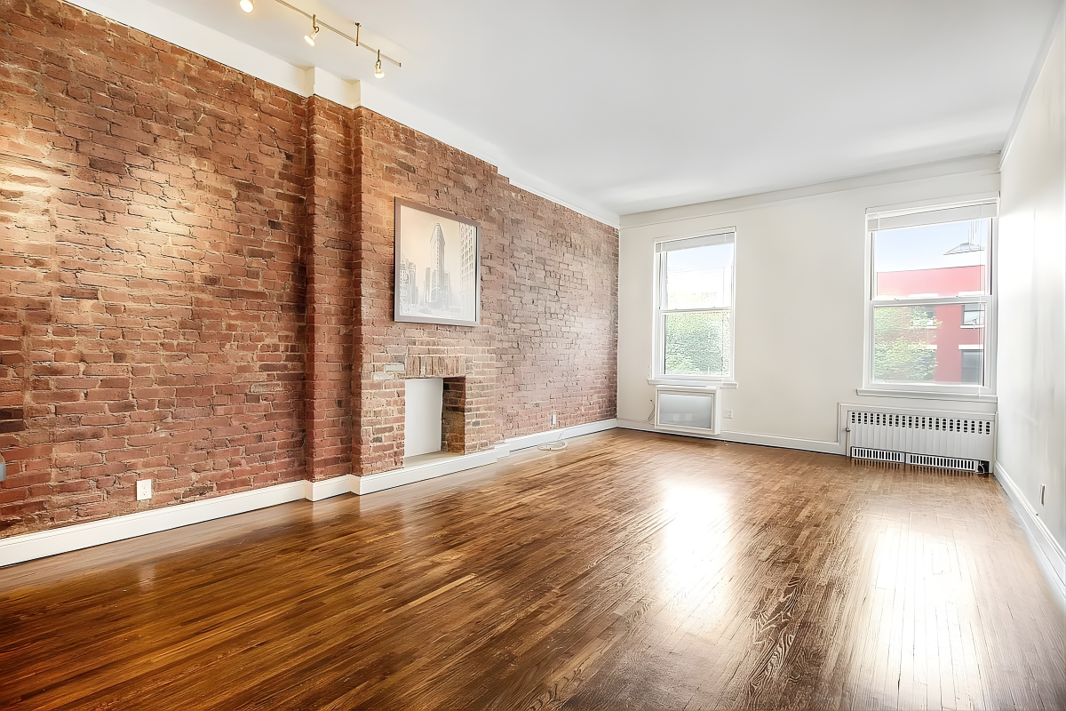 219 West 14th Street, Unit 4F Manhattan, NY 10011 - Photo 1 of 7 a view of an empty room with wooden floor and a window