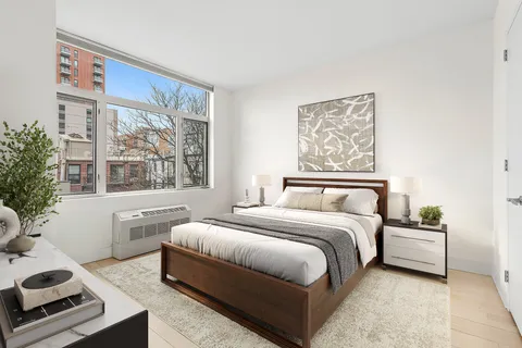 a bedroom with a large bed and a window