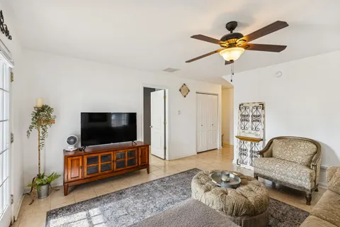 a bedroom with a bed and a table with potted plants