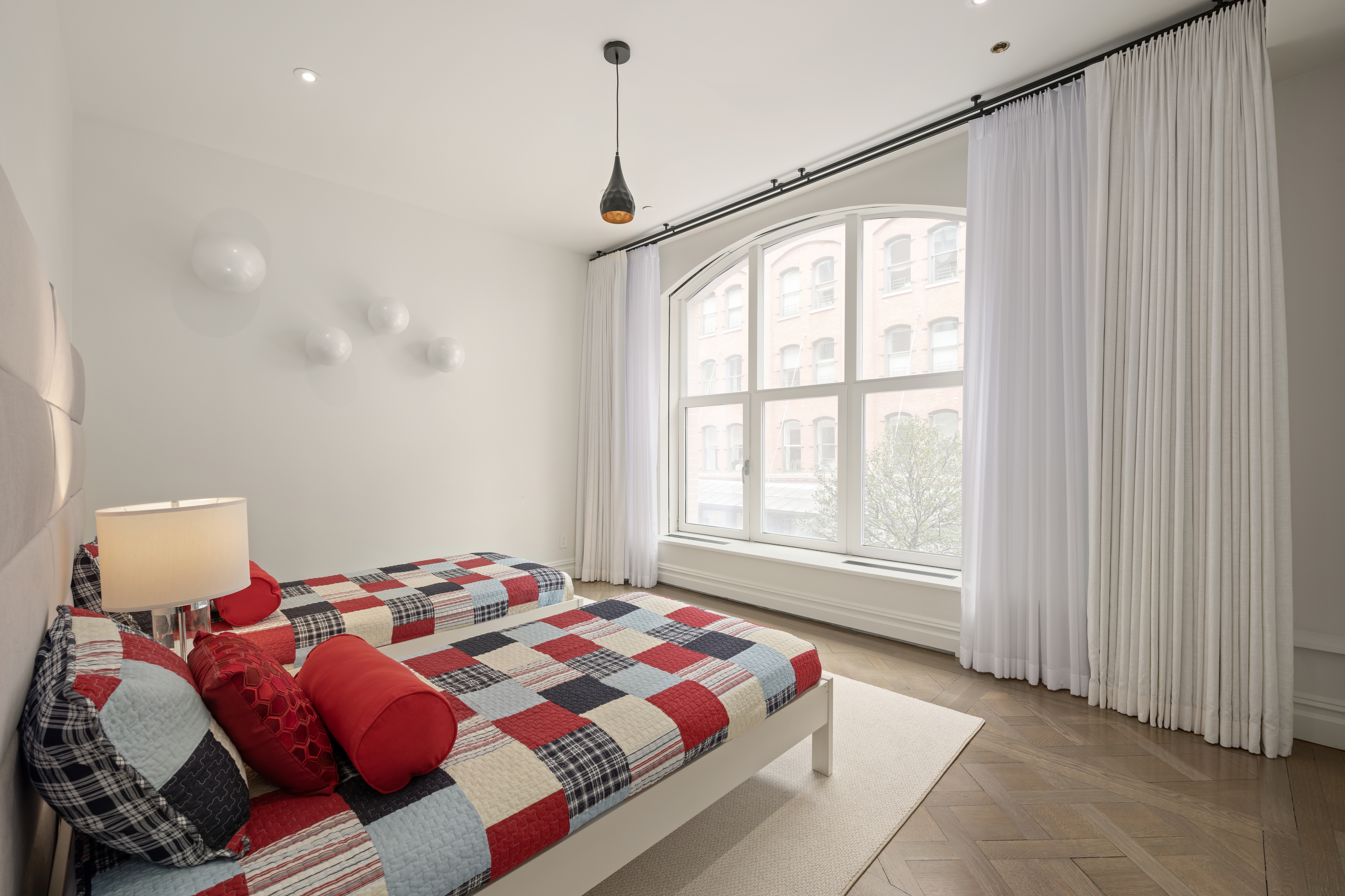 415 Washington Street, Unit 1B Manhattan, NY 10013 - Photo 10 of 16 a bedroom with a bed and a window