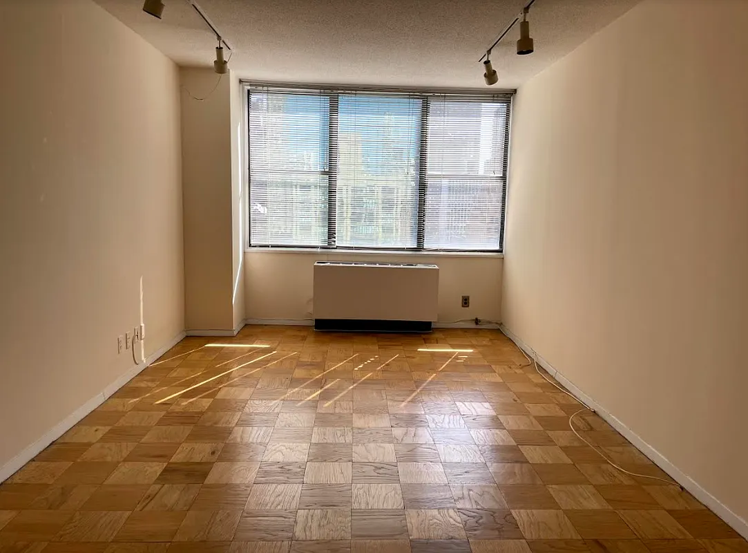301 East 45th Street, Unit 20D Manhattan, NY 10017 - Photo 5 of 8 a view of an empty room with a window