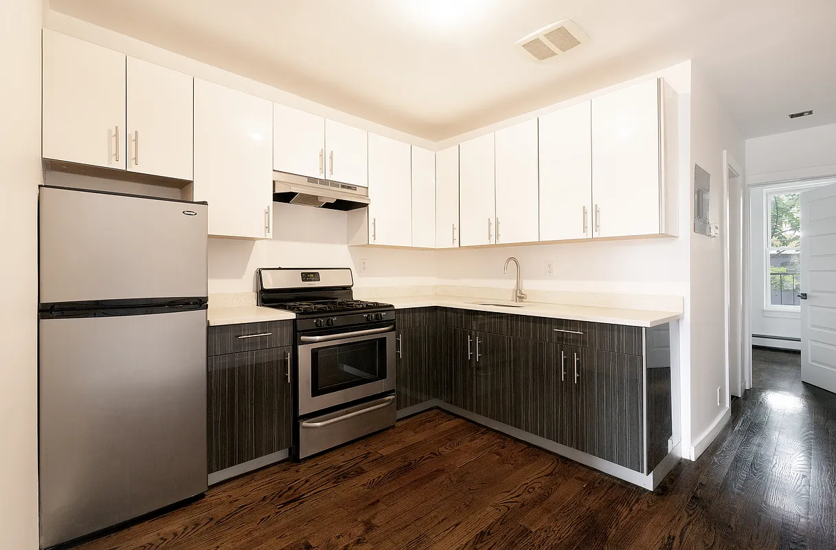 834 Halsey Street, Unit 2 Brooklyn, NY 11233 - Photo 6 of 10 a kitchen with a sink stove and refrigerator