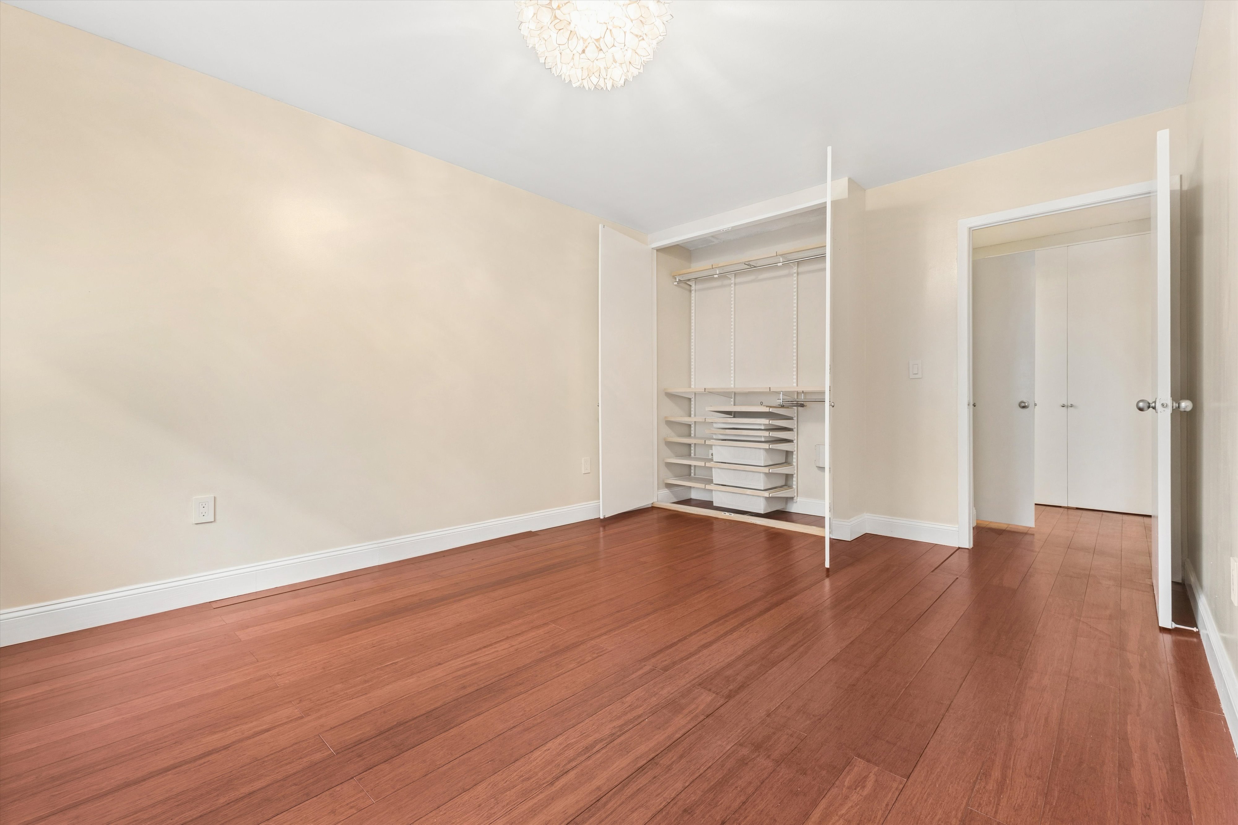1919 Madison Avenue, Unit 418 Manhattan, NY 10035 - Photo 10 of 16 a view of an empty room with wooden floor