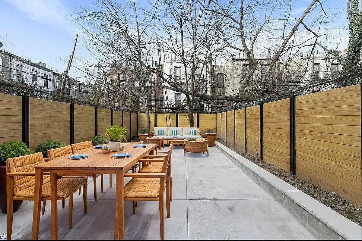 a view of a patio with a table and chairs and couches