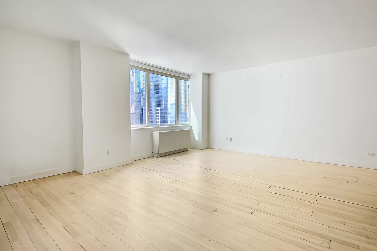 322 West 57th Street, Unit 38Q Manhattan, NY 10019 - Photo 2 of 16 an empty room with windows