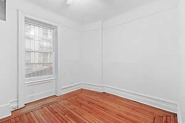 50 East 96th Street, Unit 2A Manhattan, NY 10128 - Photo 6 of 7 a view of a room with wooden floor and windows