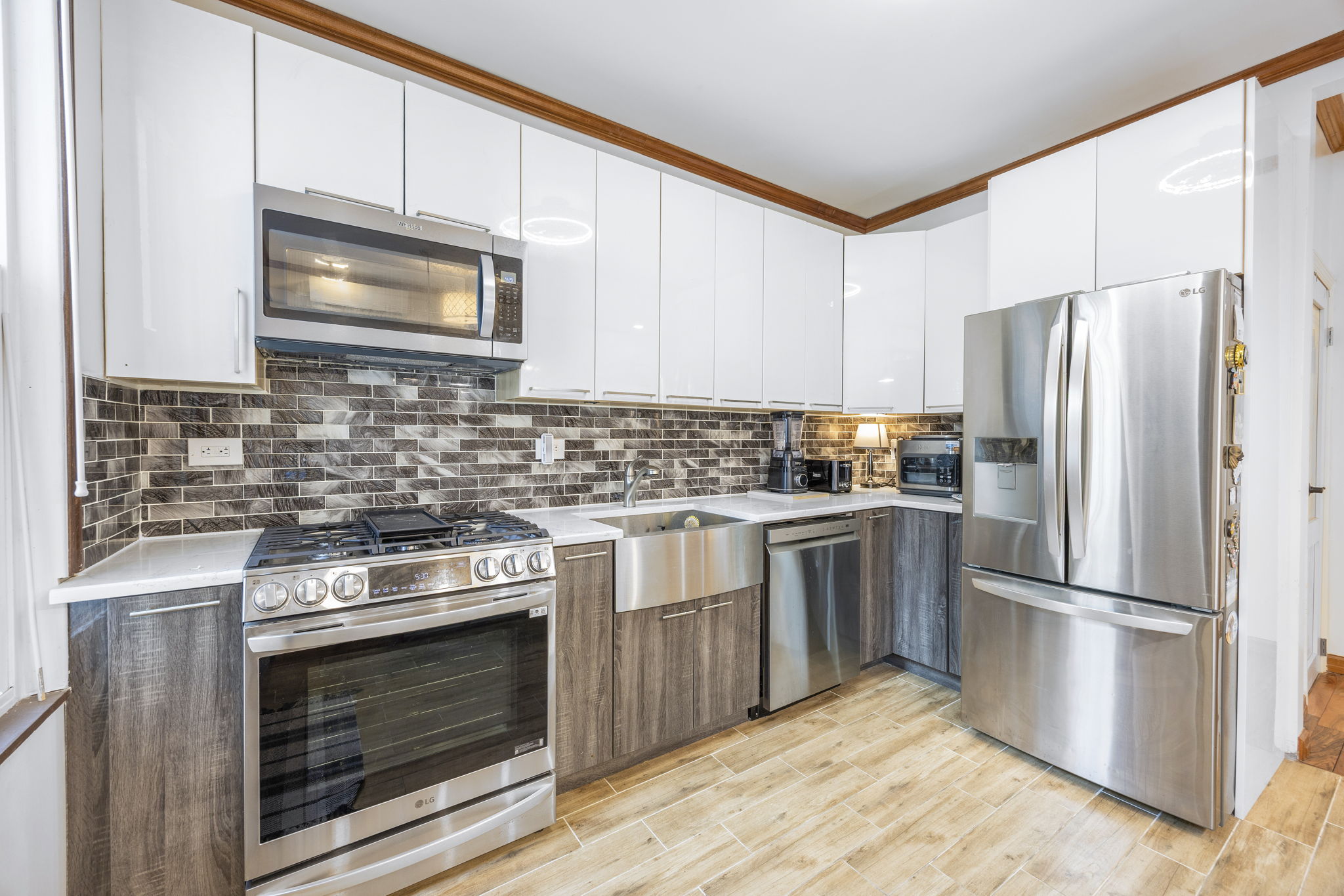 25-69 46th Street Queens, NY 11103 - Photo 21 of 33 a kitchen with a stove microwave and refrigerator