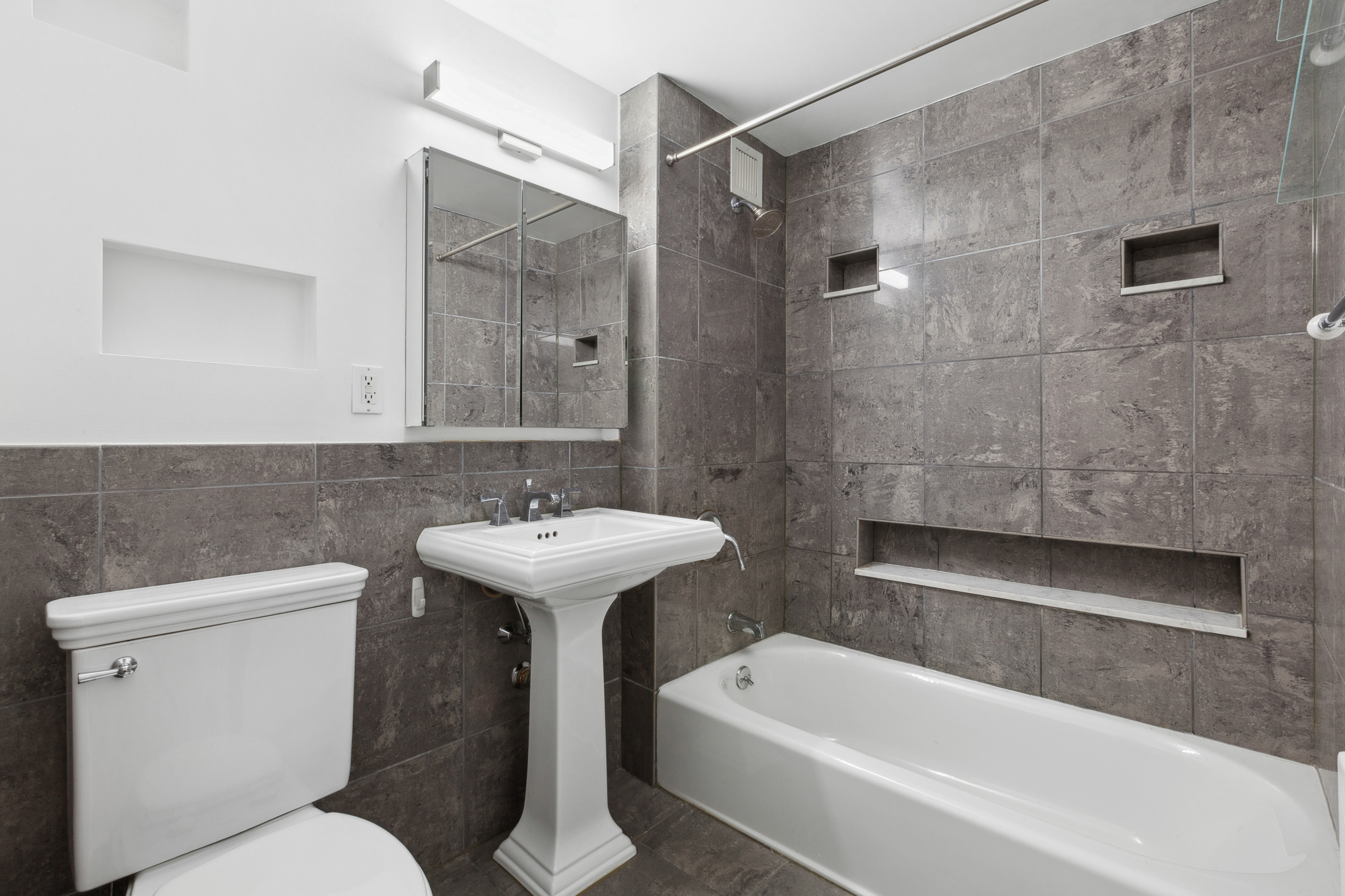 266 West 115th Street, Unit 2B Manhattan, NY 10026 - Photo 9 of 11 a bathroom with a sink a toilet and bathtub