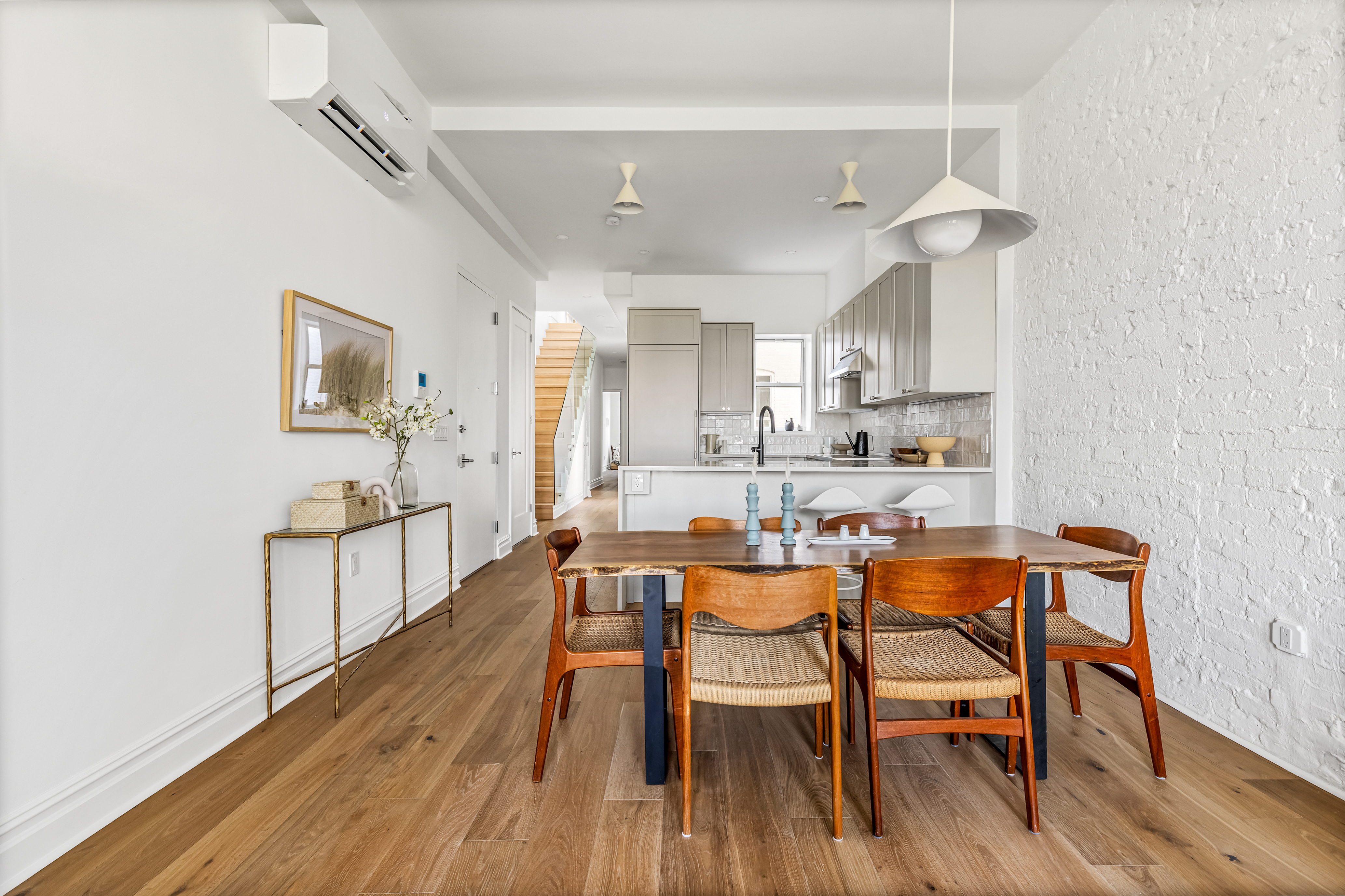 744 Park Place, Unit 4A Brooklyn, NY 11216 - Photo 2 of 13 a dining room with stainless steel appliances kitchen island a table and chairs in it