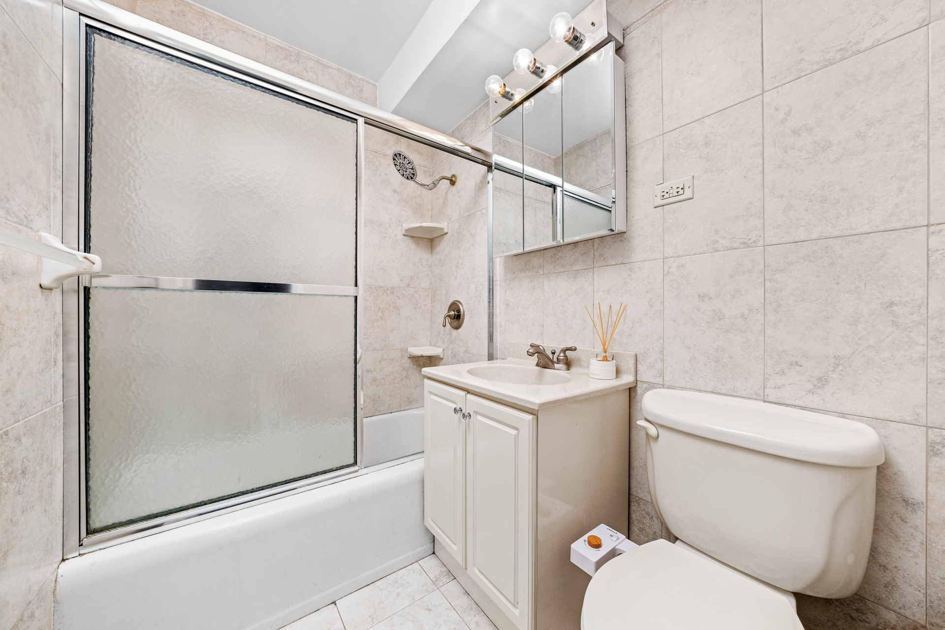 122 Ashland Place, Unit 14F Brooklyn, NY 11201 - Photo 8 of 16 a bathroom with a toilet a sink and shower