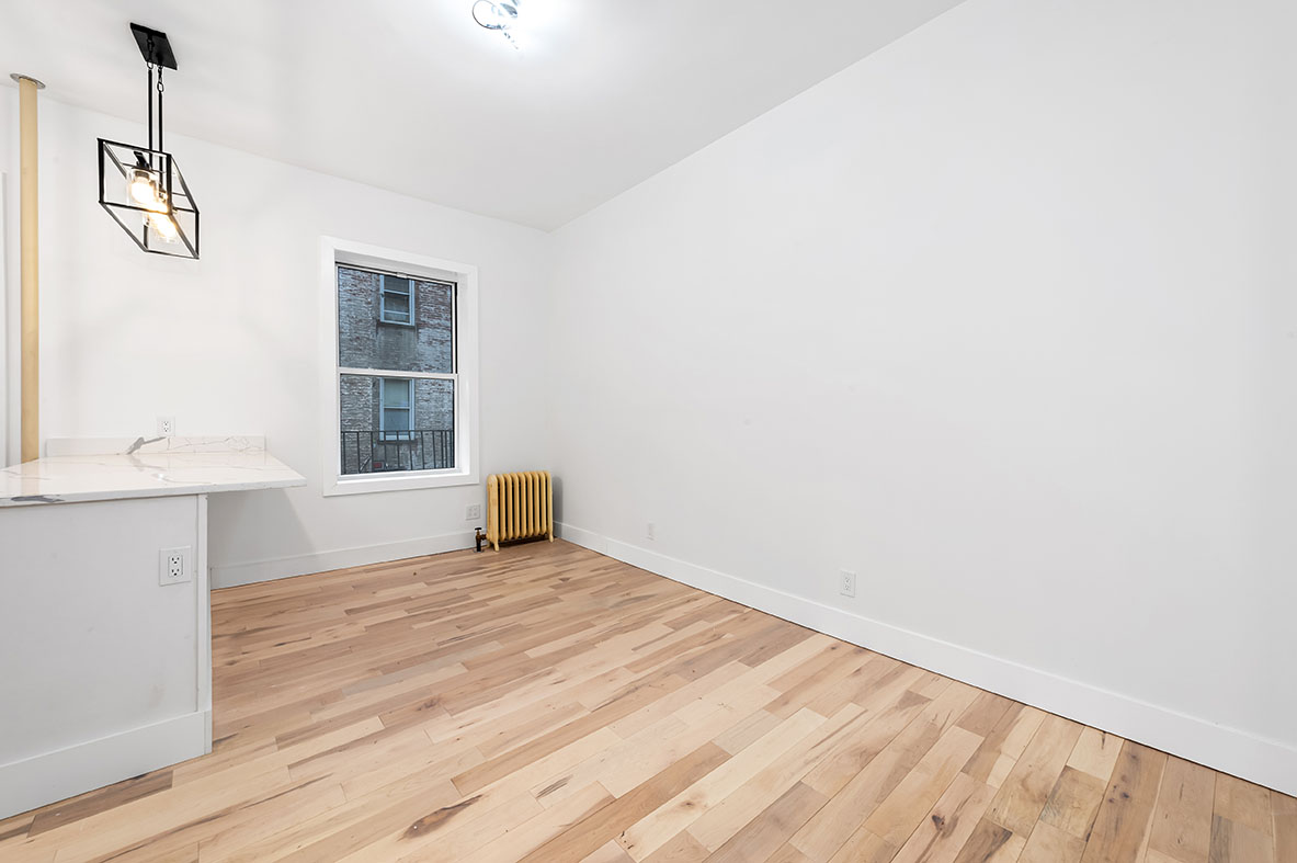 88 Brooklyn Avenue, Unit A3 Brooklyn, NY 11216 - Photo 9 of 12 a view of a room with wooden floor and cabinet