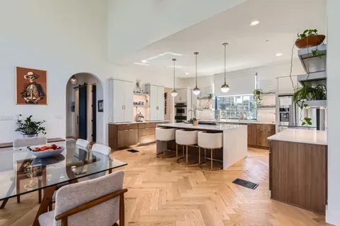 a large kitchen with a table and chairs in it