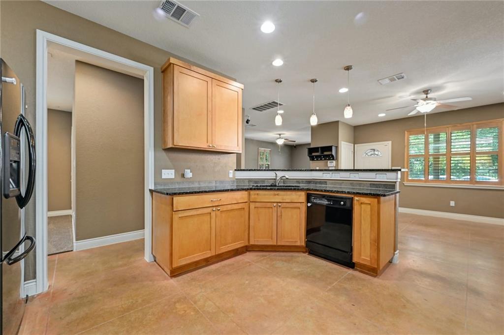 1102 Clermont Avenue Austin, TX 78702 - Photo 12 of 30 a large kitchen with stainless steel appliances granite countertop a stove a sink and a refrigerator