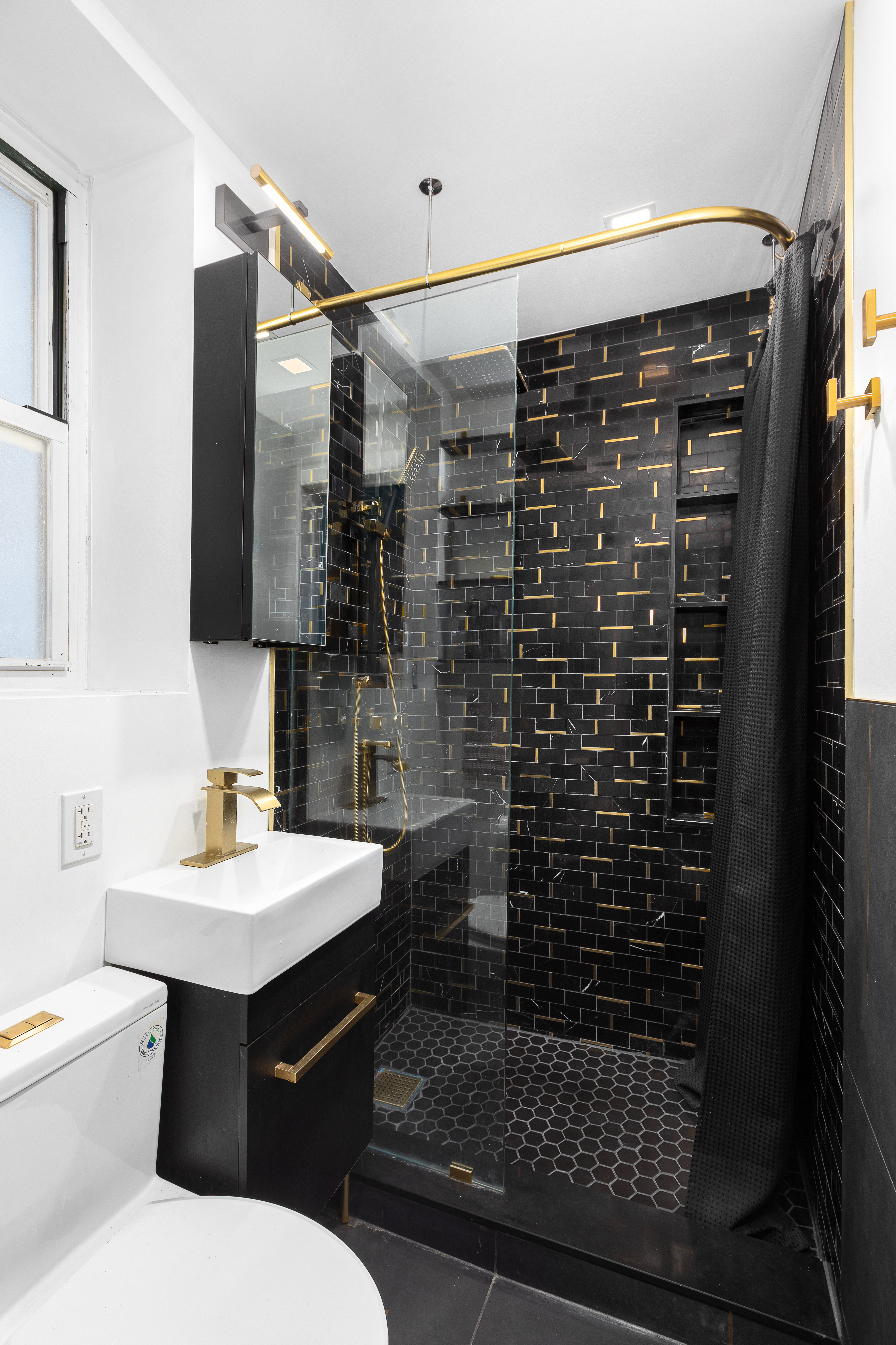 786 9th Avenue, Unit 2FN Manhattan, NY 10019 - Photo 5 of 6 a bathroom with a sink toilet and shower