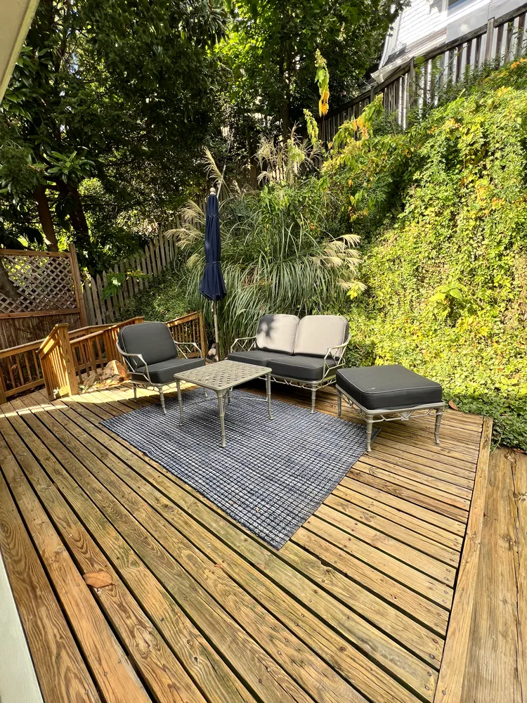 a view of a wooden chairs on the roof deck
