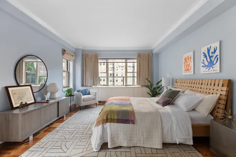 a bedroom with bed and a large window