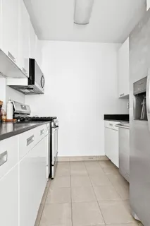 a kitchen with a stove top oven and cabinets
