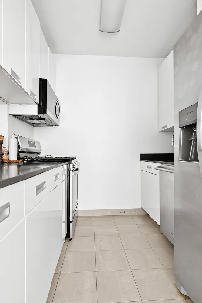 a kitchen with a stove top oven and cabinets
