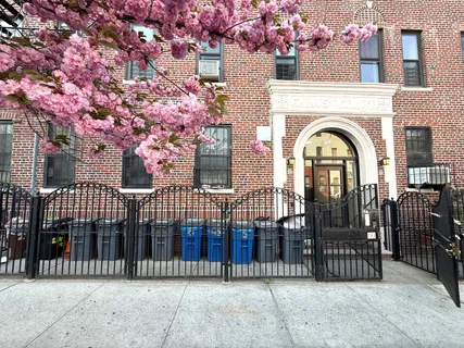 a view of a brick house with a iron gate