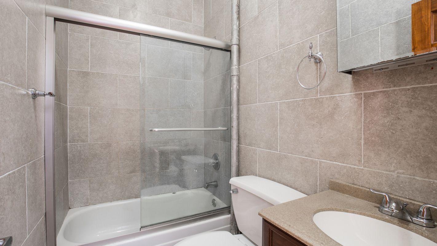 27 Brevoort Place, Unit 2 Brooklyn, NY 11216 - Photo 9 of 9 a bathroom with a sink and a mirror