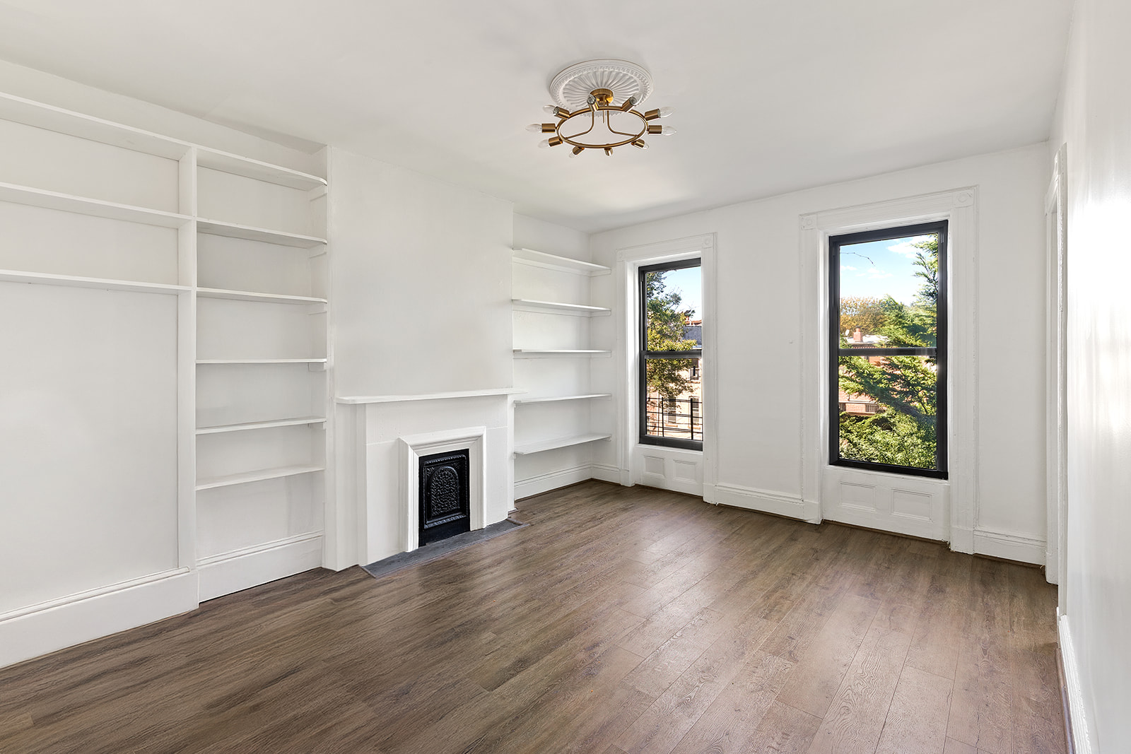 441 MacDonough Street Brooklyn, NY 11233 - Photo 9 of 13 a view of an empty room with a window and wooden floor