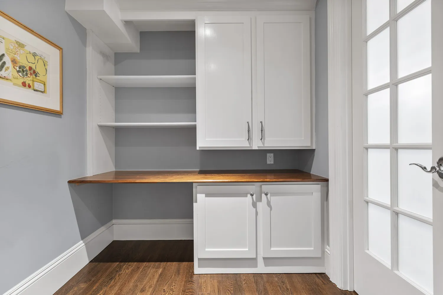a view of cabinets and wooden floor