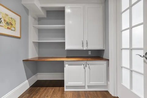 a view of cabinets and wooden floor